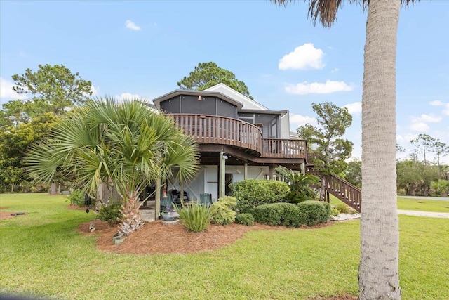 40 Carrol Dr, Crawfordville, FL 32327 - back of property featuring a sunroom, stairs, a wooden deck, and a lawn