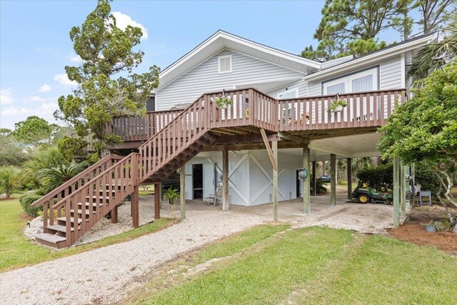 40 Carrol Dr, Crawfordville, FL 32327 - back of property featuring a carport, a deck, stairway, and dirt driveway