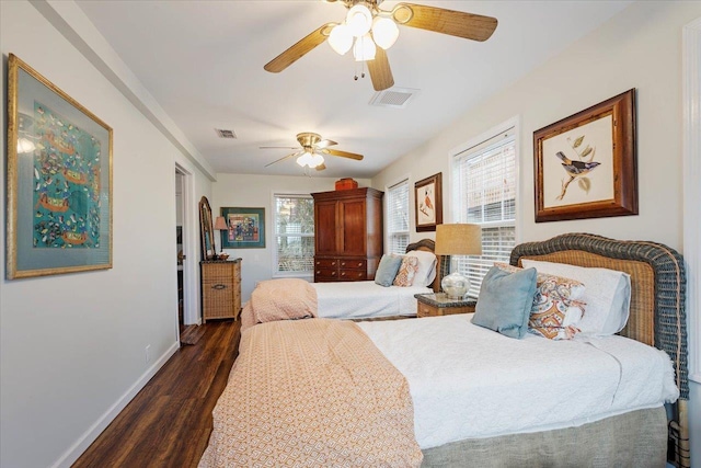 40 Carrol Dr, Crawfordville, FL 32327 - bedroom featuring dark wood-style flooring, multiple windows, baseboards, and ceiling fan