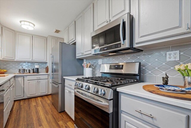 40 Carrol Dr, Crawfordville, FL 32327 - kitchen featuring appliances with stainless steel finishes, backsplash, light countertops, and dark wood-style floors