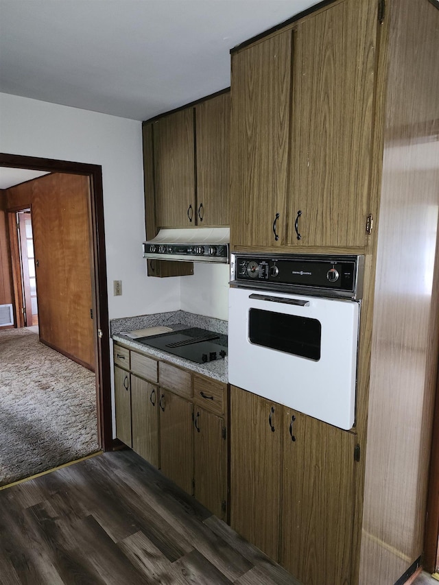 512 Hampton Ave, Tallahassee, FL 32310 - kitchen featuring black electric cooktop, ventilation hood, dark wood-type flooring, visible vents, and white oven