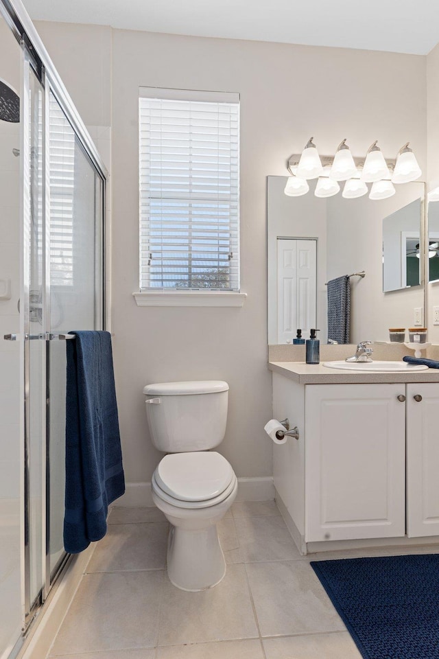 bathroom with tile patterned floors, vanity, toilet, and a shower with shower door