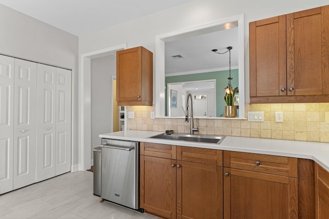 kitchen with sink, hanging light fixtures, tasteful backsplash, ornamental molding, and stainless steel dishwasher