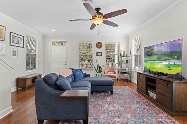 living room with dark wood-type flooring, ceiling fan, and crown molding