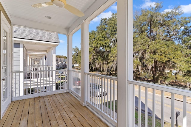 unfurnished sunroom featuring ceiling fan