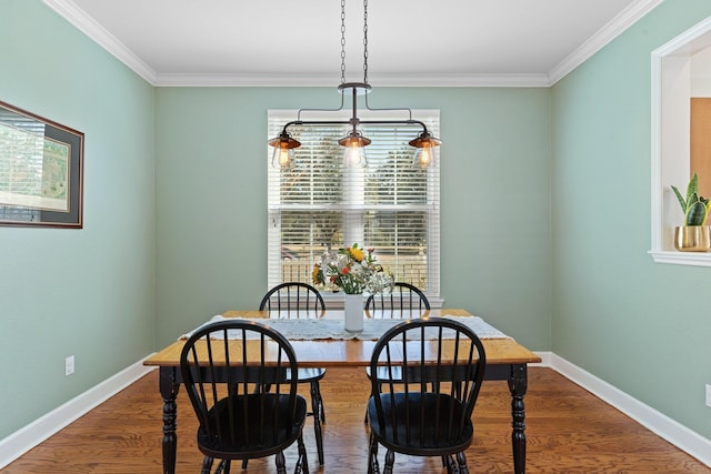 dining area featuring hardwood / wood-style floors and ornamental molding