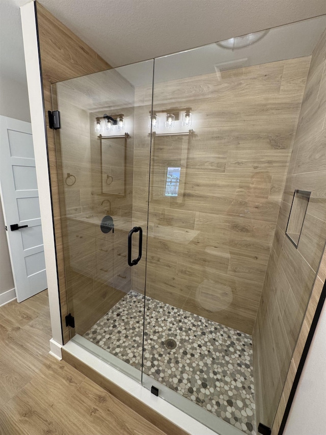 75 Chickat Trl, Crawfordville, FL 32327 - full bathroom featuring a shower stall and wood finished floors