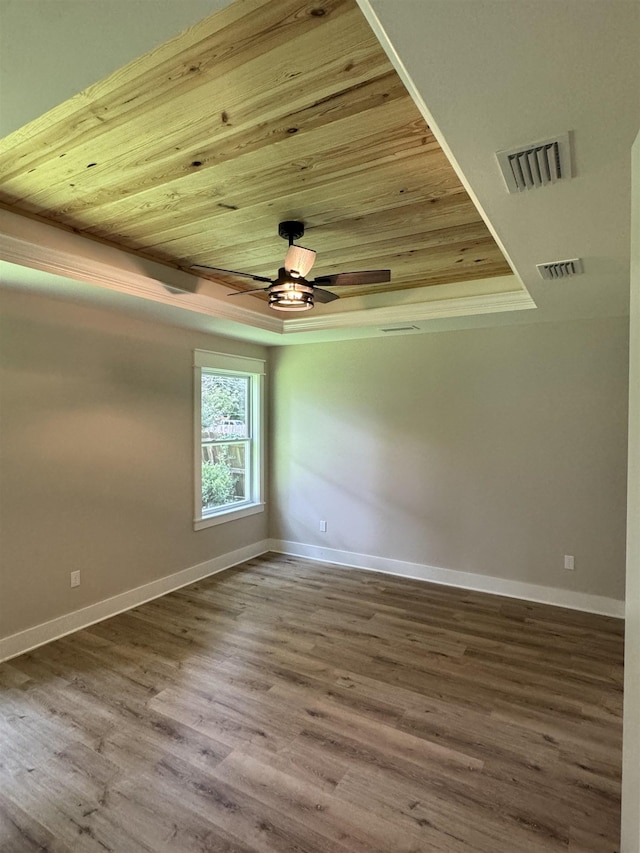 75 Chickat Trl, Crawfordville, FL 32327 - empty room with a tray ceiling, wood ceiling, wood finished floors, and a ceiling fan