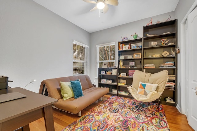 sitting room with ceiling fan and light hardwood / wood-style flooring