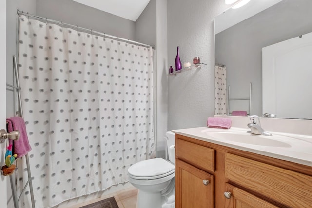 bathroom with vanity, toilet, and tile patterned flooring