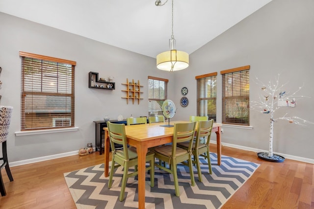 dining area with lofted ceiling and light hardwood / wood-style flooring