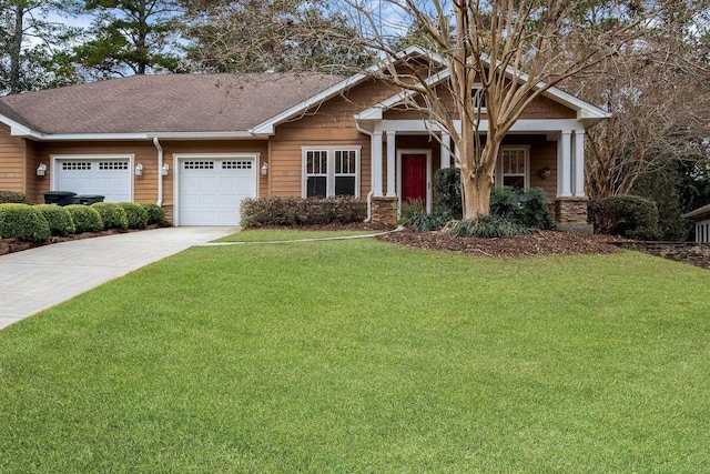 craftsman inspired home with a garage and a front lawn