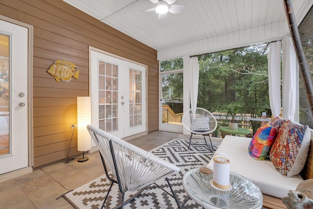 sunroom with a wealth of natural light, wood ceiling, ceiling fan, and french doors