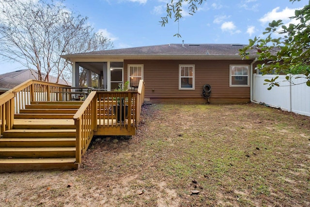 back of property featuring a sunroom and a deck