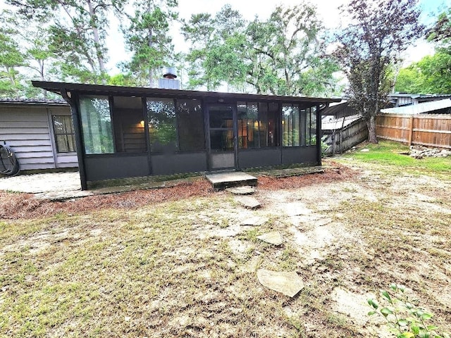 2405 Lanrell Dr, Tallahassee, FL 32303 - rear view of house featuring a sunroom and a chimney