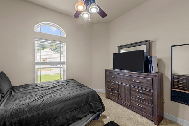 carpeted bedroom with vaulted ceiling and ceiling fan