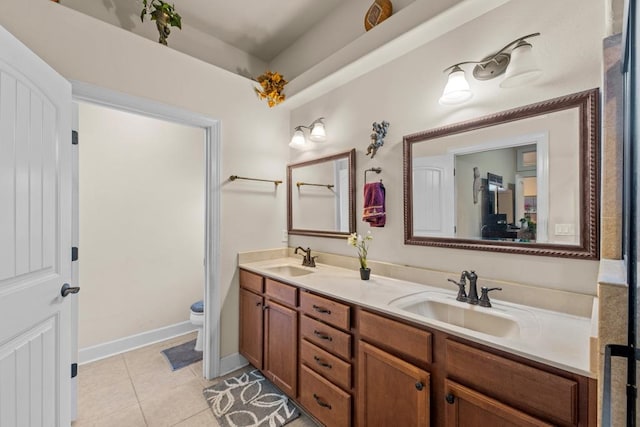 bathroom featuring toilet, vanity, and tile patterned floors