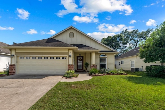 view of front of house with a garage, central AC, and a front lawn