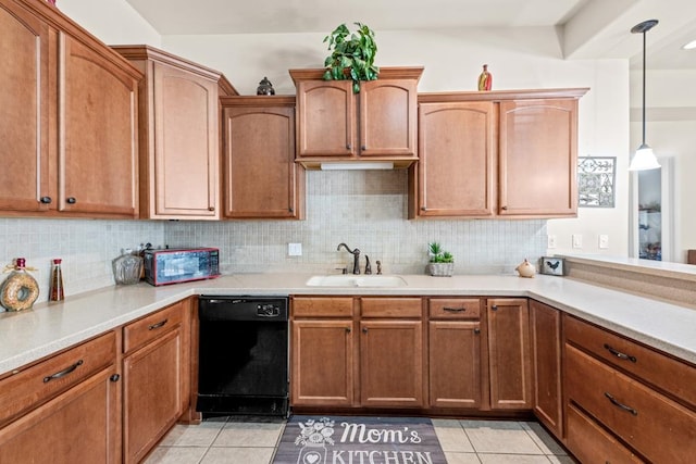 kitchen with decorative light fixtures, light tile patterned floors, sink, decorative backsplash, and dishwasher