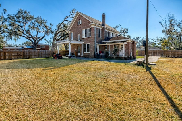 rear view of property with a yard