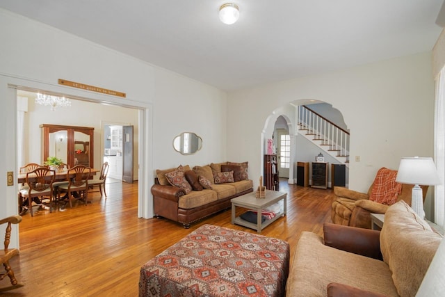 living room featuring hardwood / wood-style floors and a notable chandelier