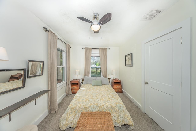 carpeted bedroom featuring visible vents, ceiling fan, and baseboards