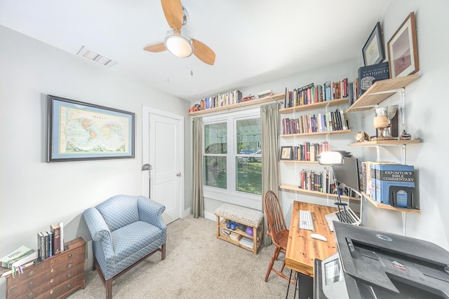 carpeted office space with visible vents, baseboards, and ceiling fan