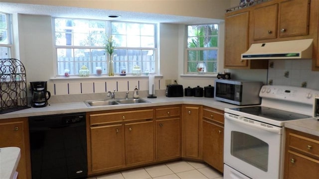 kitchen with backsplash, dishwasher, sink, and electric range