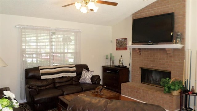 living room with a brick fireplace, lofted ceiling, and ceiling fan