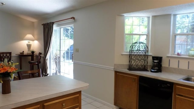 kitchen featuring dishwasher, sink, and light tile patterned floors