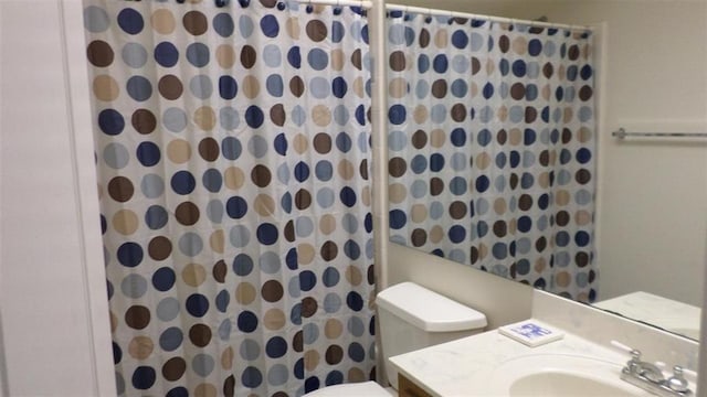 bathroom with vanity, a shower with shower curtain, and toilet