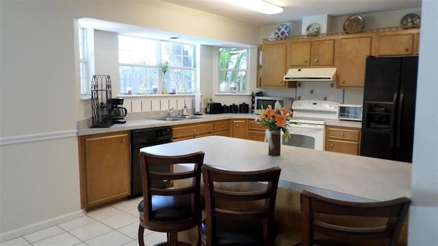 kitchen with sink, light tile patterned floors, and black appliances