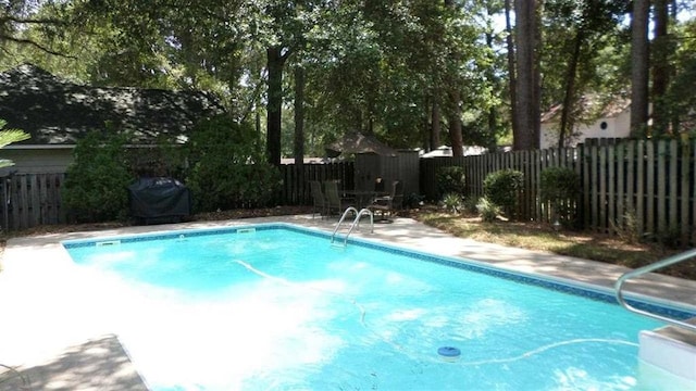 view of pool featuring grilling area