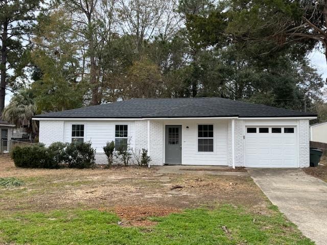 ranch-style home with driveway, brick siding, an attached garage, and a shingled roof