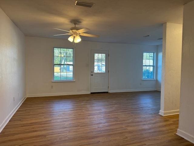 entryway featuring ceiling fan, baseboards, visible vents, and dark wood finished floors