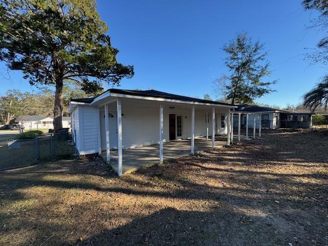 view of front facade featuring fence and a patio