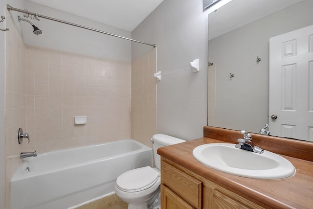 bathroom with washtub / shower combination, vanity, and toilet