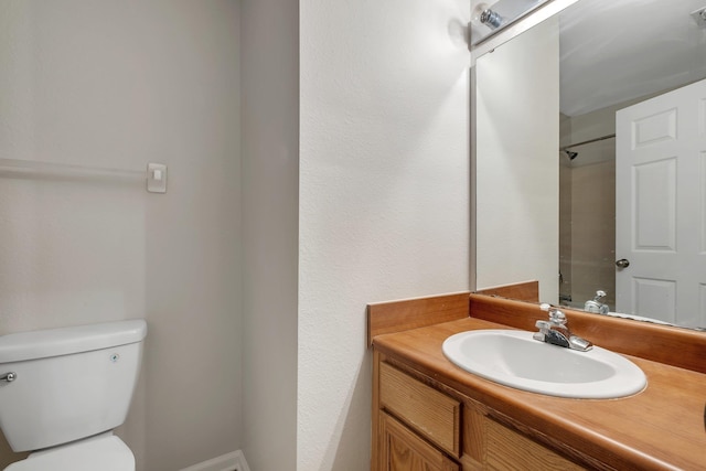 bathroom with visible vents, toilet, and vanity