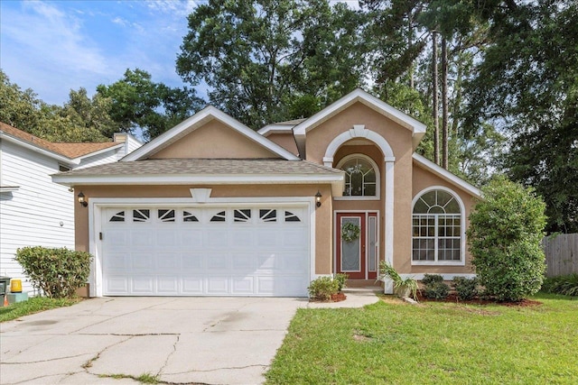 2942 Tewkesbury Trce, Tallahassee, FL 32309 - view of front of property featuring concrete driveway, an attached garage, stucco siding, a front yard, and a shingled roof