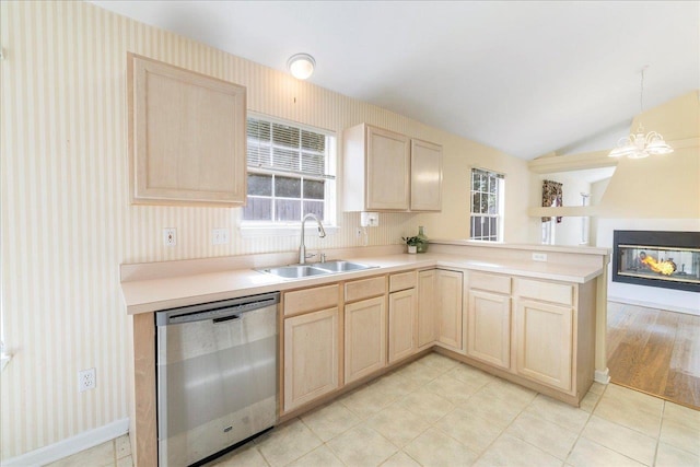 2942 Tewkesbury Trce, Tallahassee, FL 32309 - kitchen featuring stainless steel dishwasher, light brown cabinetry, a sink, a peninsula, and lofted ceiling