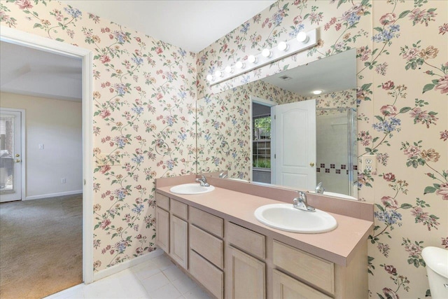 2942 Tewkesbury Trce, Tallahassee, FL 32309 - full bathroom with wallpapered walls, double vanity, baseboards, a shower with shower door, and tile patterned flooring