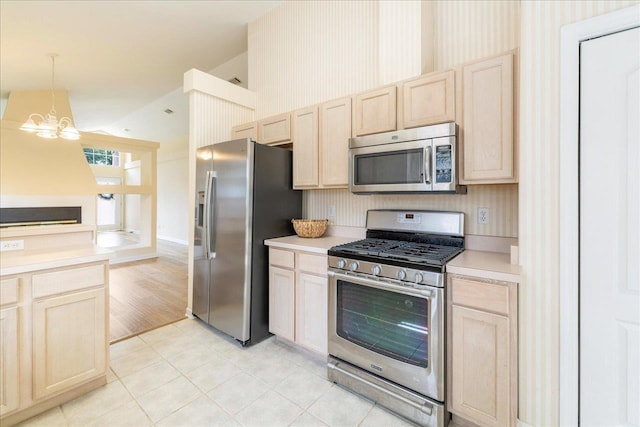 2942 Tewkesbury Trce, Tallahassee, FL 32309 - kitchen featuring appliances with stainless steel finishes, lofted ceiling, wallpapered walls, light brown cabinetry, and a chandelier