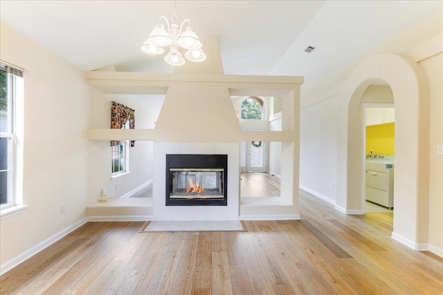 2942 Tewkesbury Trce, Tallahassee, FL 32309 - unfurnished living room with washer / clothes dryer, healthy amount of natural light, and wood finished floors
