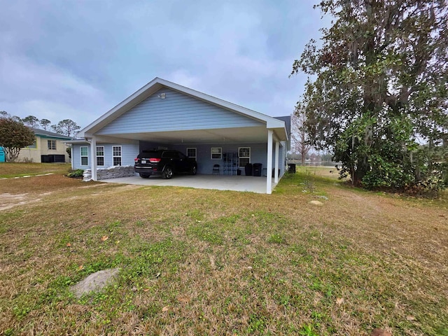 view of side of home with a carport and a lawn