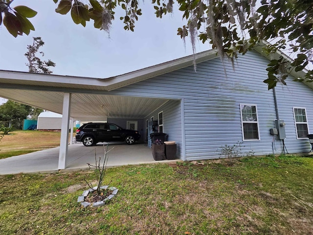 view of property exterior with a carport and a lawn