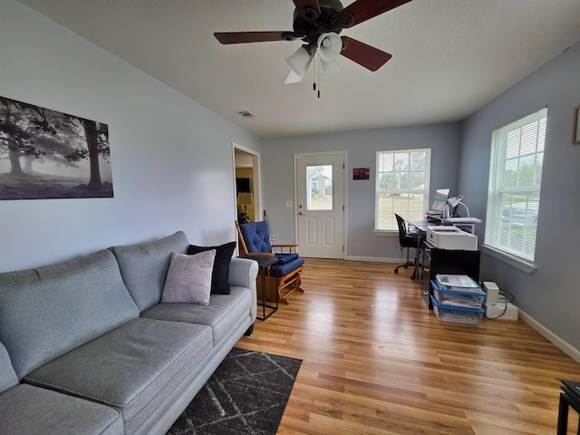 living room featuring ceiling fan and light wood-type flooring