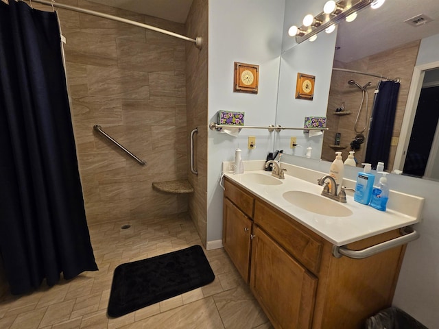 bathroom featuring walk in shower and vanity