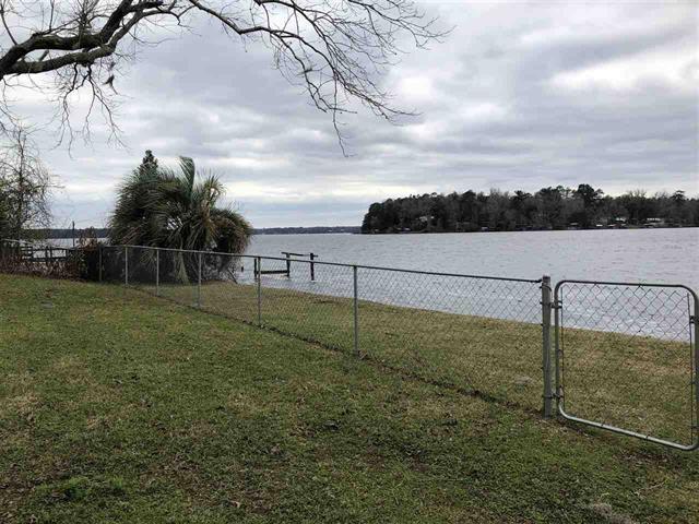 view of yard featuring fence and a water view