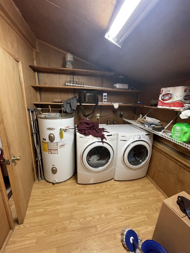 washroom with laundry area, light wood-style flooring, electric water heater, and separate washer and dryer