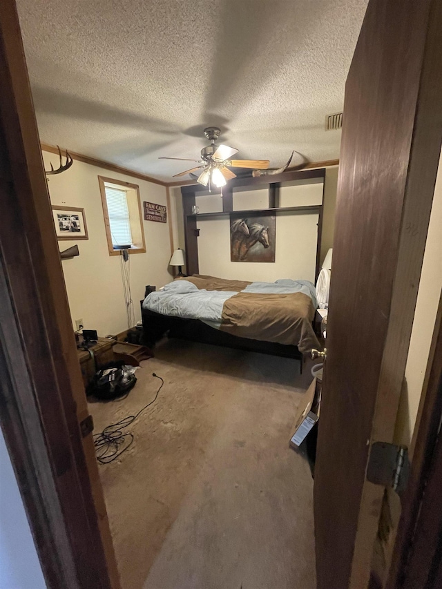 bedroom featuring visible vents, a textured ceiling, and ceiling fan